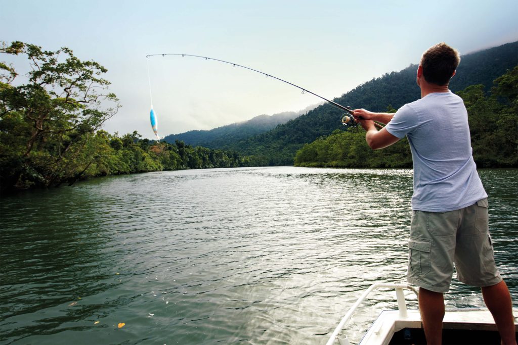 man standing up fishing