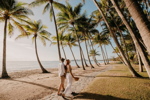 Couple walking down the Esplanade of Palm Cove