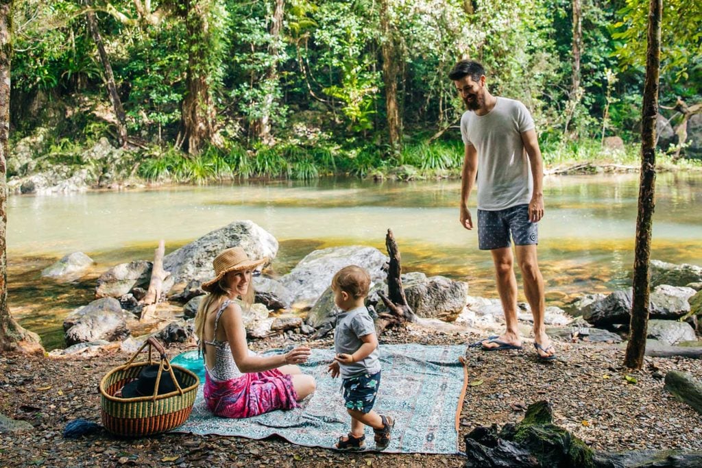 Family enjoying picnic next to the creek at Crystal Cascades