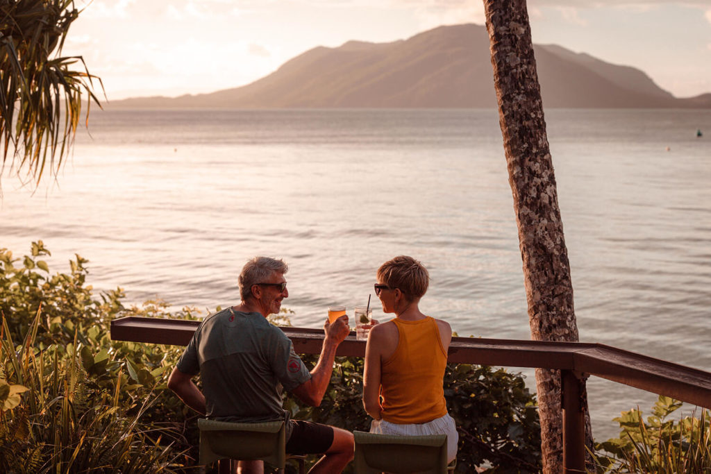 Couple having sunset drinks at Foxy's Bar at Fitzroy Island