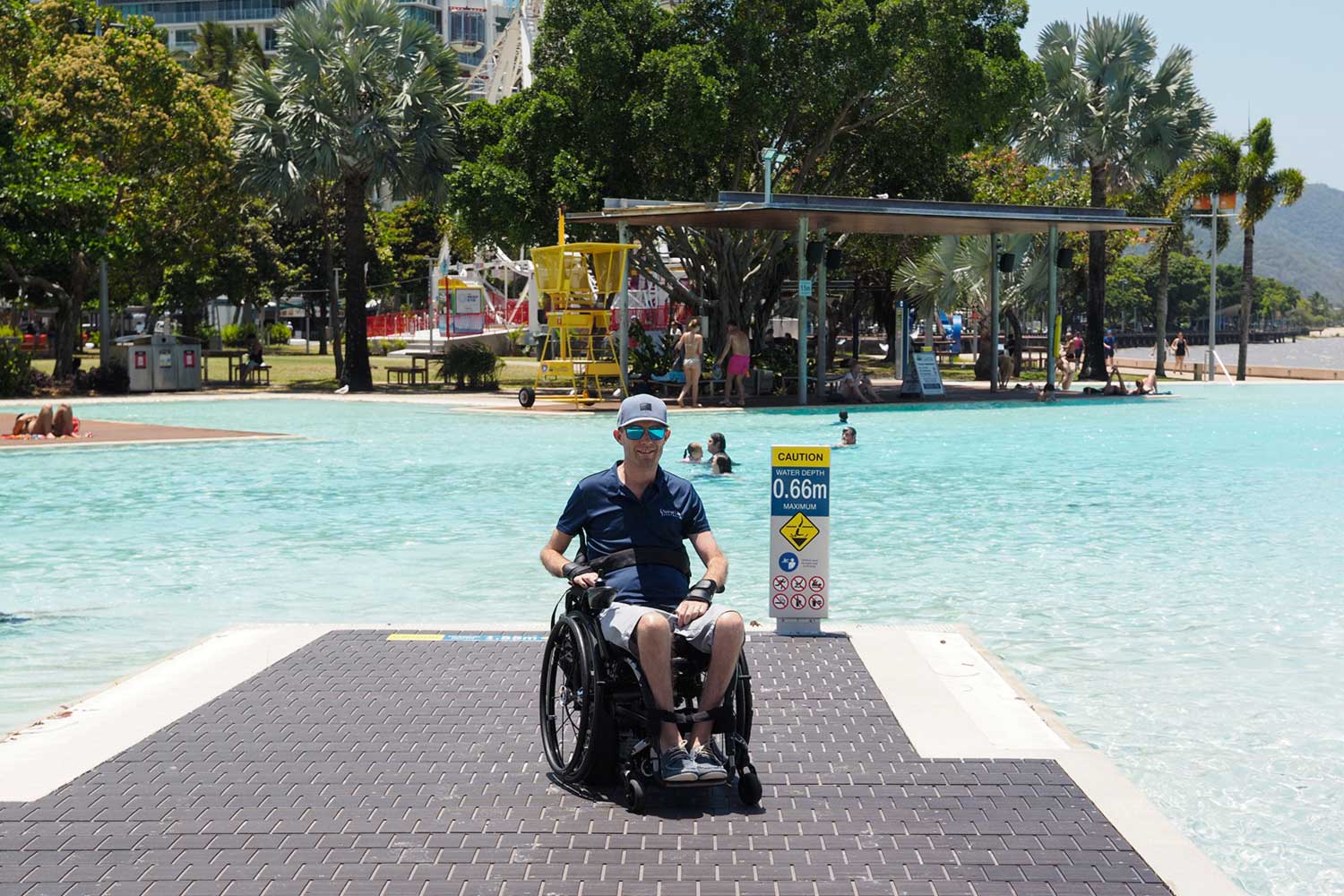 Man in wheelchair in front of Cairns Esplanade Lagoon